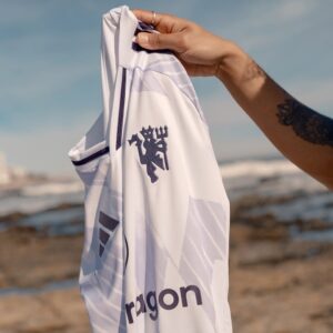 Manchester United 2025/26 Adidas Away Jersey in white with red and black details, inspired by classic 90s designs and United’s fearless away spirit.