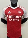 Close-up shot of the Adidas Arsenal Home Jersey 2025/26 in bold red with white sleeves and gold detailing. The embroidered Arsenal club crest sits proudly on the chest, showcasing high-quality stitching. Modern shirt pattern and lightweight fabric texture are visible, highlighting premium design and authentic match-ready style.